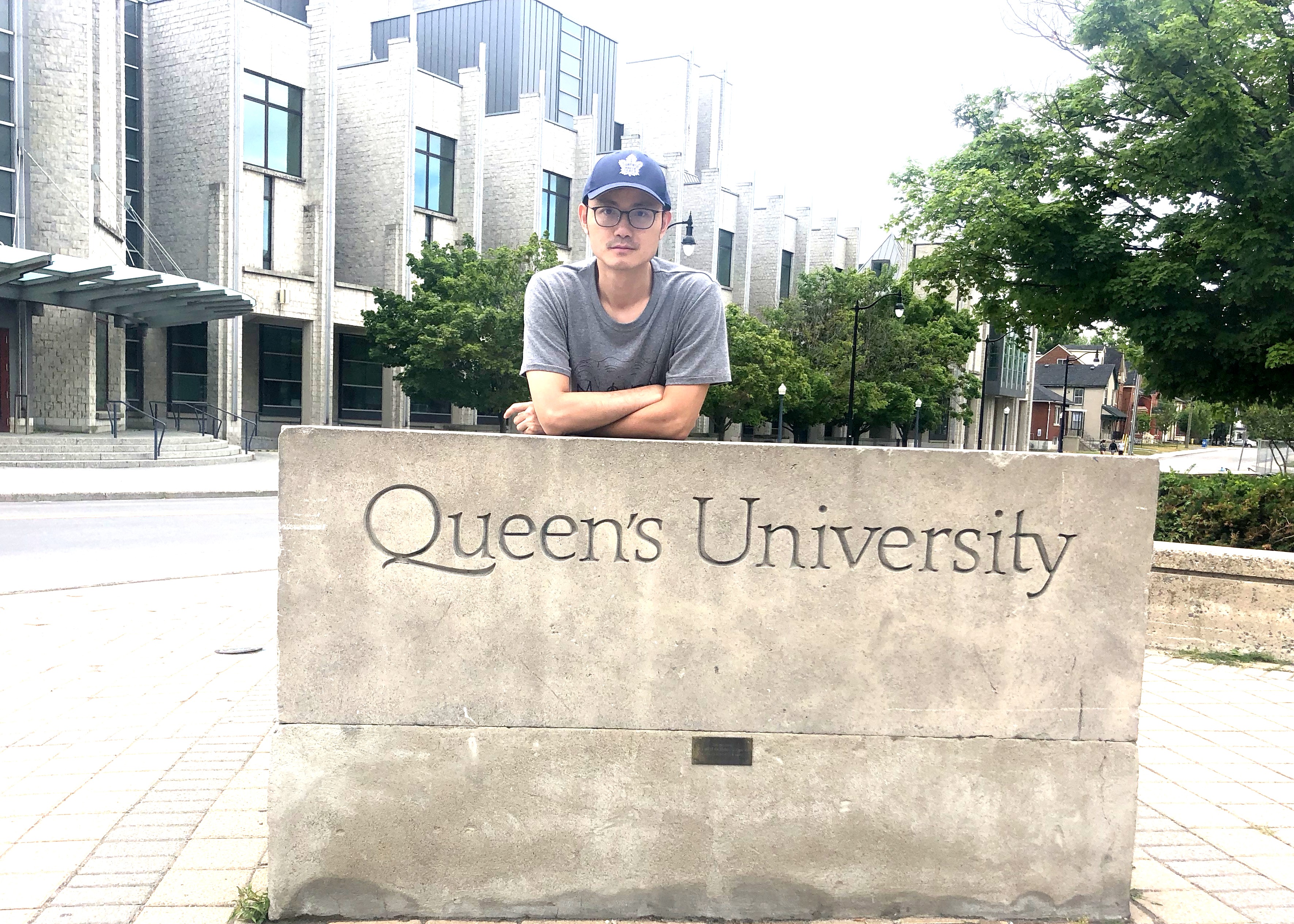 Zheng Chen in front of Queen's sign